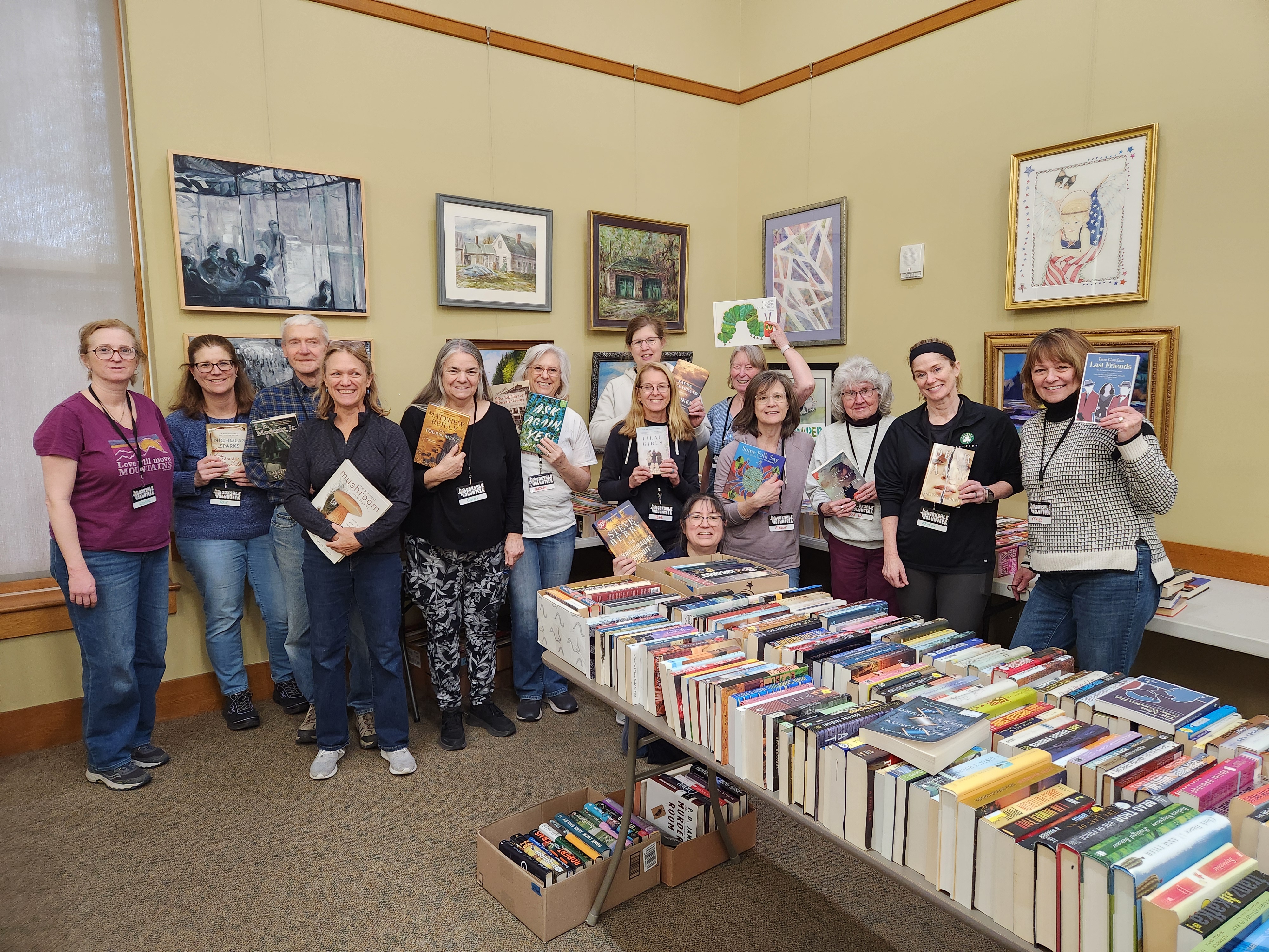 People holding books at a book sale