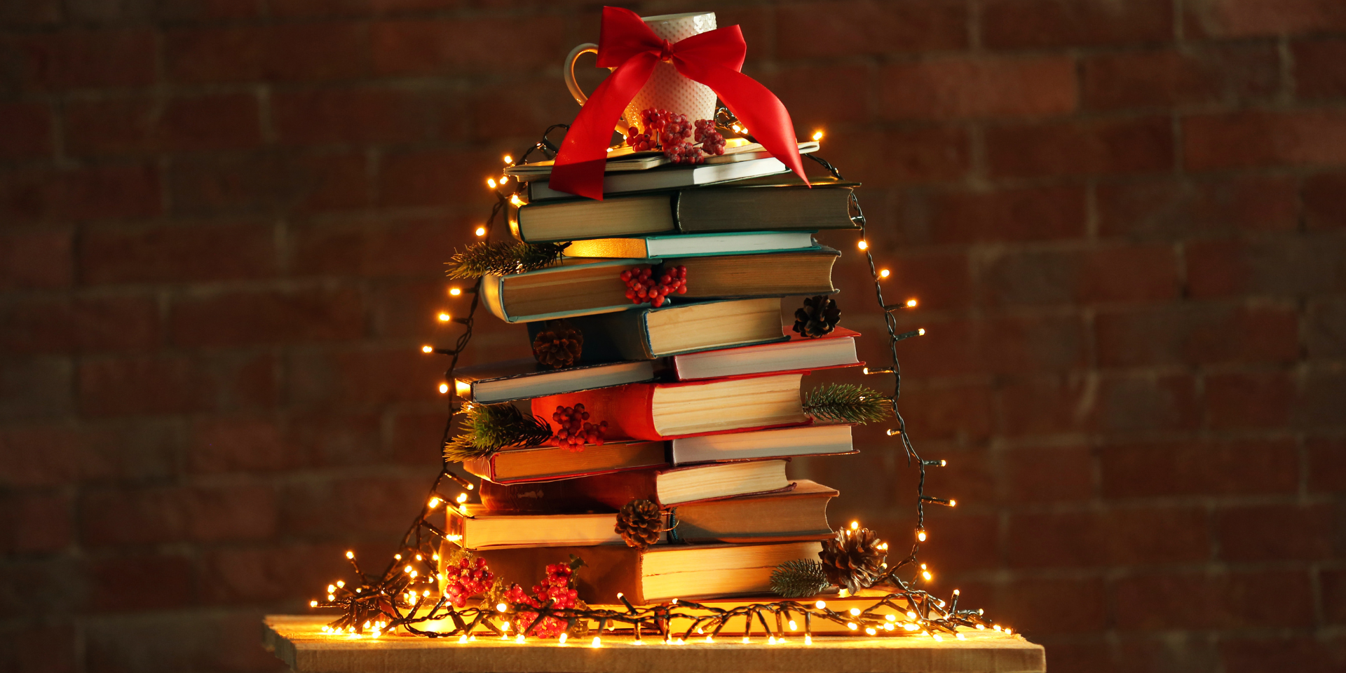 Stack of books in holiday lights.